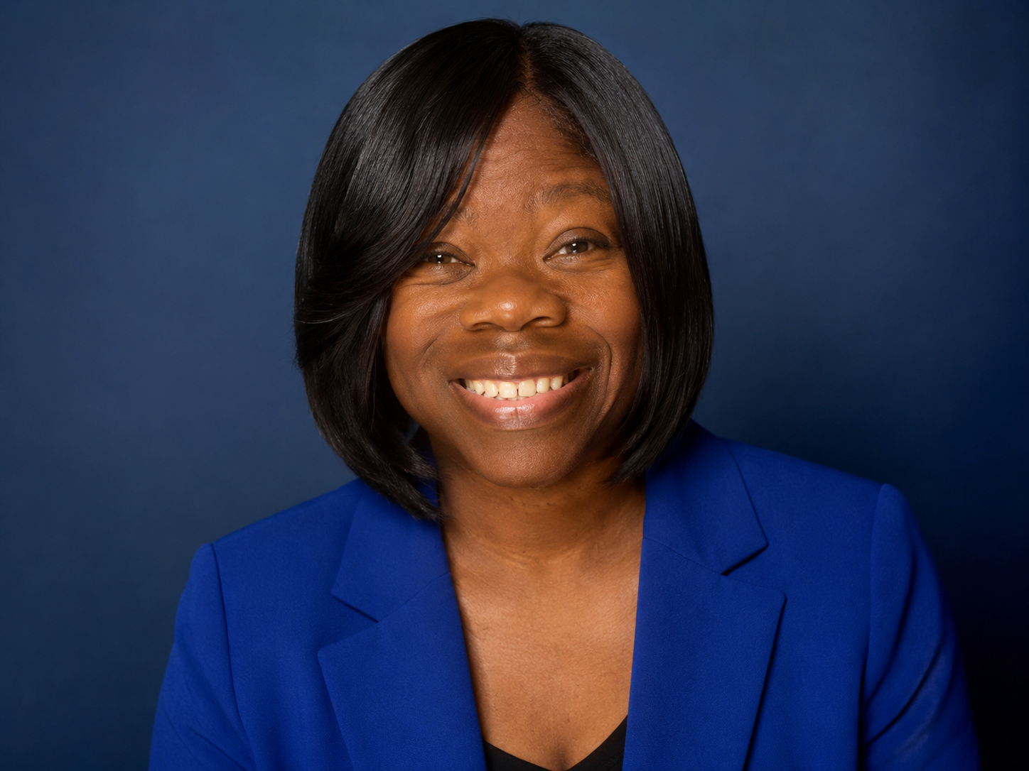 Charla Winbush, Chief AI & Empowerment Officer of G.R.O.W. AI, smiling in a royal blue blazer.